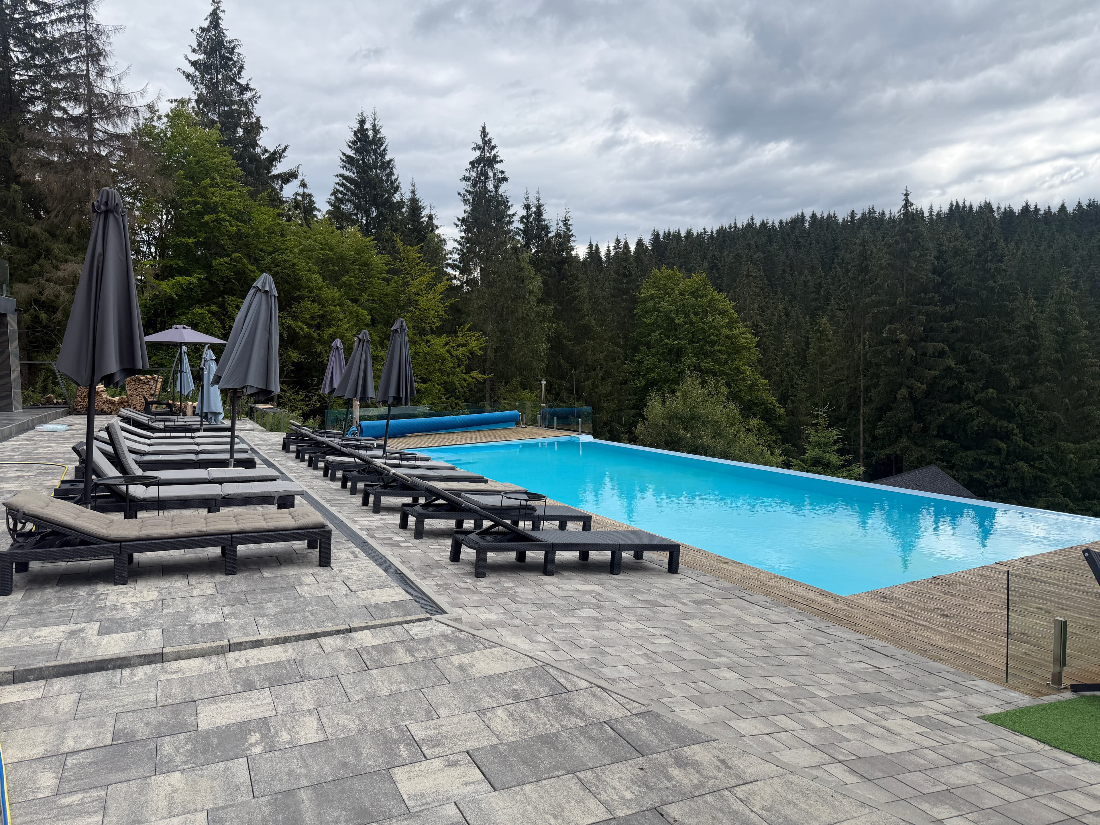 Forest pool photographed for the mountain-stay concept